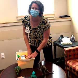 Therapist Casie LaMunyon gathers toys for PCIT therapy